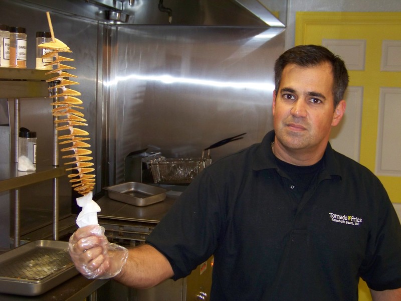 Tom Minio Jr., co-owner of Tornado Fries in Rehoboth Beach, shows off the restaurant's innovative namesake item. BY RYAN MAVITY