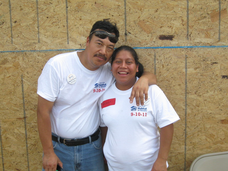 Julian Roblero and Blanca Perez smile during the Habitat for Humanity build, which when finished will give them a new home. The couple works on the house to build sweat equity as part of their agreement with Habitat. BY RACHEL SWICK MAVITY