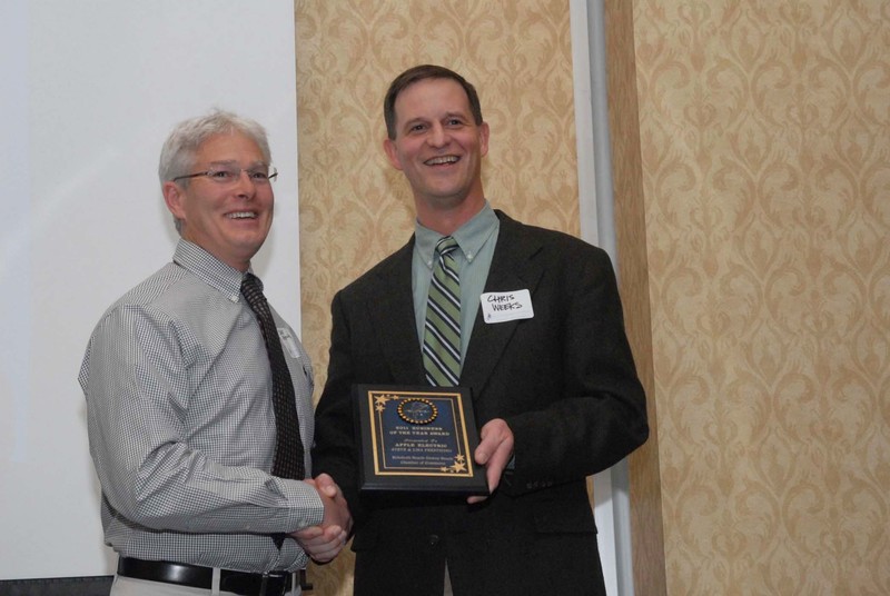 Steve Prestipino, left, of Apple Electric accepts the Business of the Year Award from Chris Weeks. BY STEVEN BILLUPS
