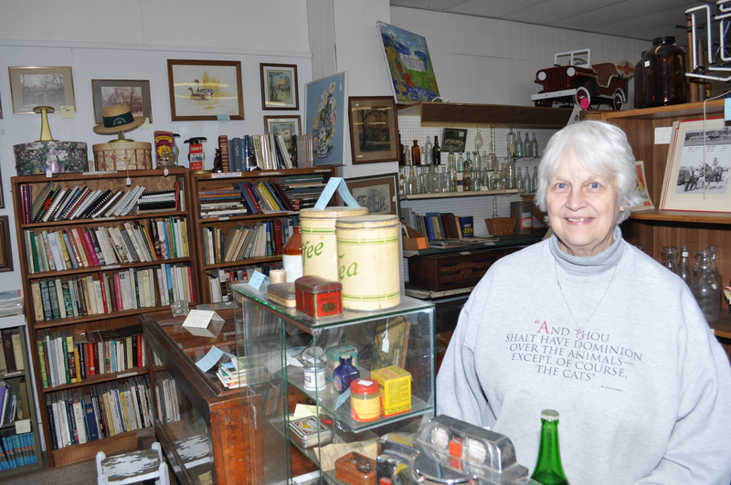 Kathryn Greig, co-owner of Antiques in Milton, stands in her Union Street store. Greig has been selling antiques for about 35 years. BY NICK ROTH