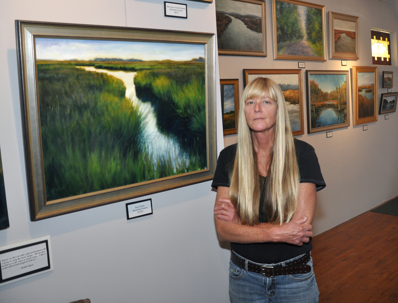 Michele Green stands in Federal Street Gallery in Milton, which will show Green's paintings until June 4. BY NICK ROTH