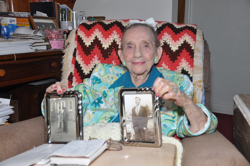 Ann Walls-McCool displays pictures of her first husband, Bill Walls, in her home/ office on Christian Street in Rehoboth Beach. BY NICK ROTH
