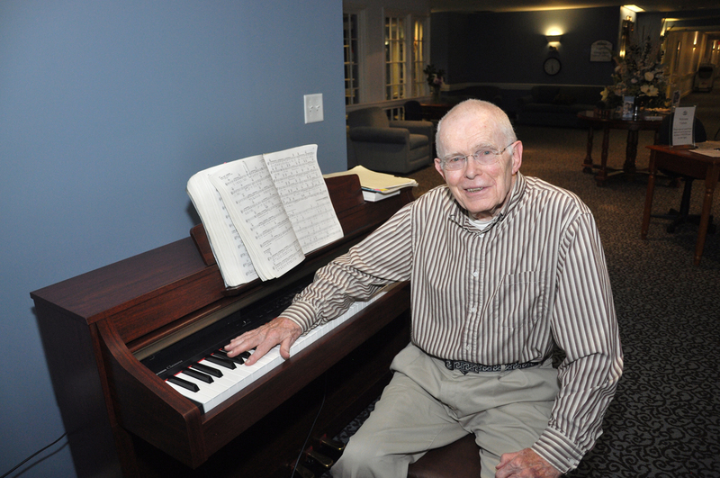 Walter Winn, 88, sits alongside the piano he plays at Cadbury Health Center in Lewes every Tuesday and Saturday. BY NICK ROTH