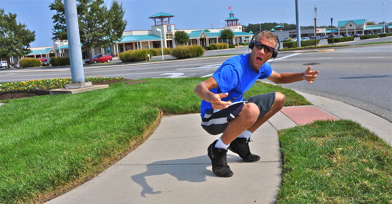 Seth Bratten gets down low as he dances on the sidewalk in front of the Tanger Outlets. He has been performing along Route 1 since June. BY RON MACARTHUR