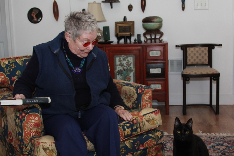 Jackie Finer enjoys the company of her black cat Treat. Treat's brother, Trick, prefers to be alone. BY MELISSA STEELE