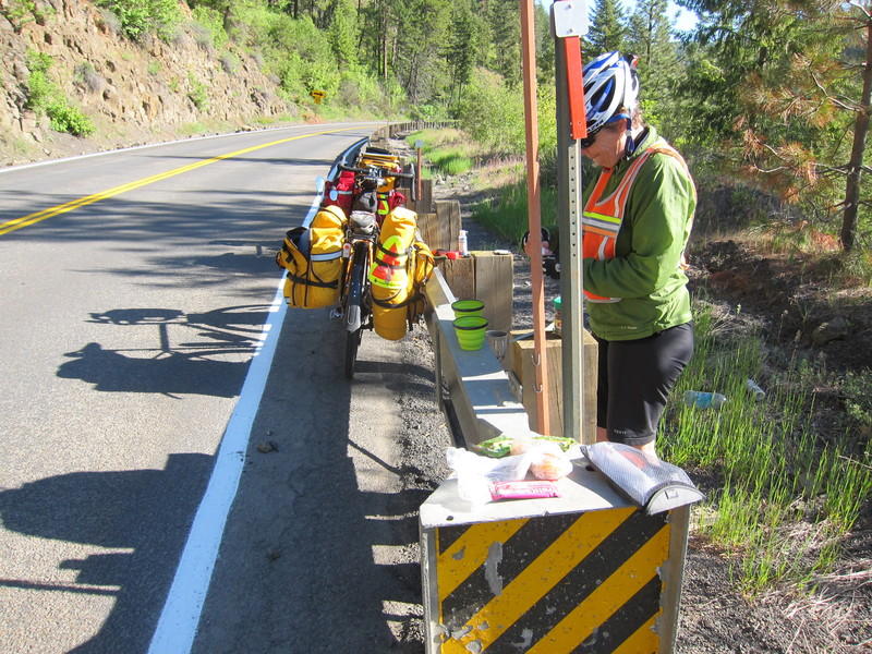 On the road, you learn to use whatever resources are available. This guardrail proved a good place to eat a breakfast of dried pears, tea and coffee, and energy bars made of chia seeds, raspberries, apples, coconut oil, rice flour and all kinds of other good stuff. The meal gave us a good lift to finish the day's ride. How about that sweet little table at the end of the guard rail? Perfect height. BY DENNIS FORNEY