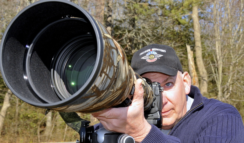 Chuck Fullmer gets his Nikon 300 and 600mm lens ready for another photo shoot. BY RON MACARTHUR