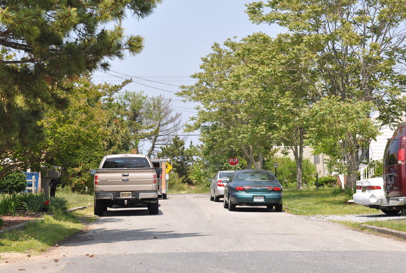 With vehicles parking on both sides of Vermont Avenue, there is just enough room for a vehicle to fit down the middle of the road. Lewes officials are looking into reclaiming rights of way on Lewes Beach to allow for more space on roadways. BY NICK ROTH