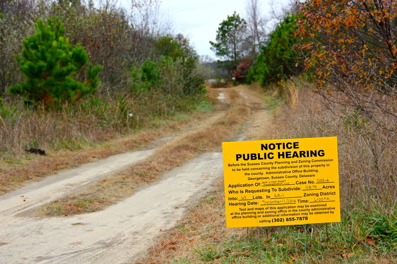 A county public hearing sign along Park Road marks the location of the proposed Harbor Point subdivision just outside Lewes city limits. BY DENNIS FORNEY