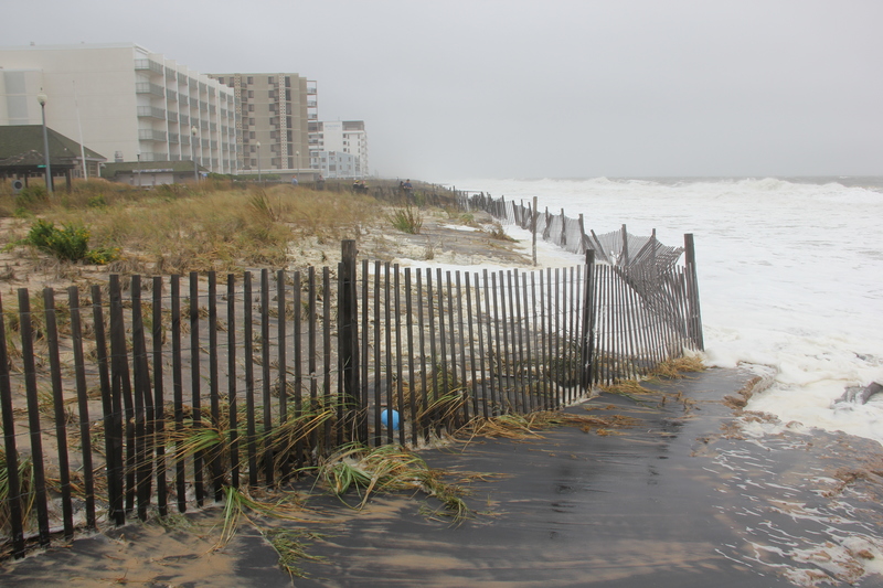 At noon on Saturday, high tide was beginning to take some dune at the north end of the Boardwalk in Rehoboth. BY DENNIS FORNEY