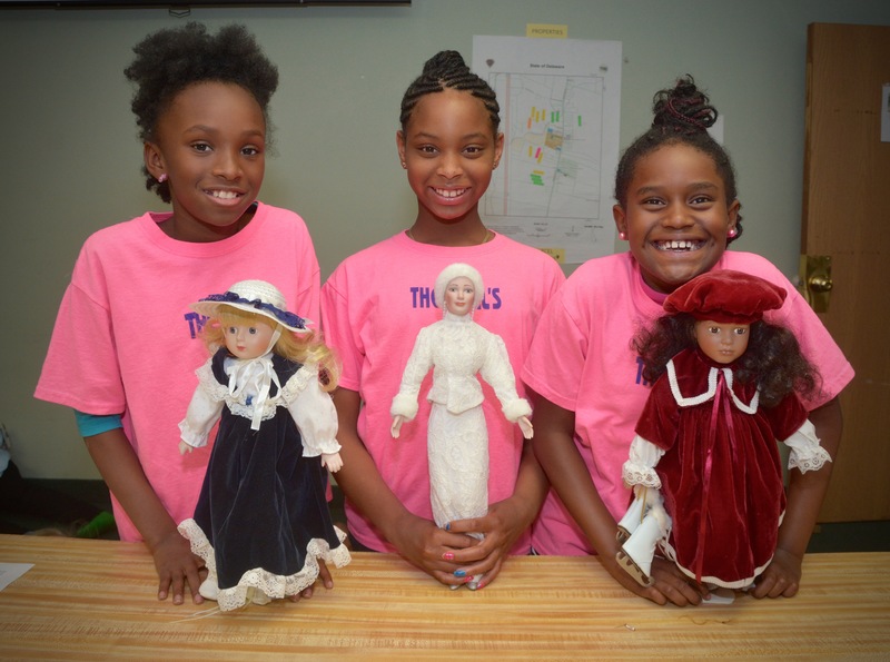 Shamaya Brown, Aaliyah Tighman and Treasure Perkins show the dolls they use as part of the program designed for young girls. BY RON MACARTHUR
