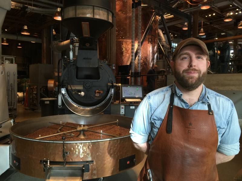 A coffee roaster named Josh at the Starbucks tasting room and roastery up Capital Hill in Seattle. BY DENNIS FORNEY