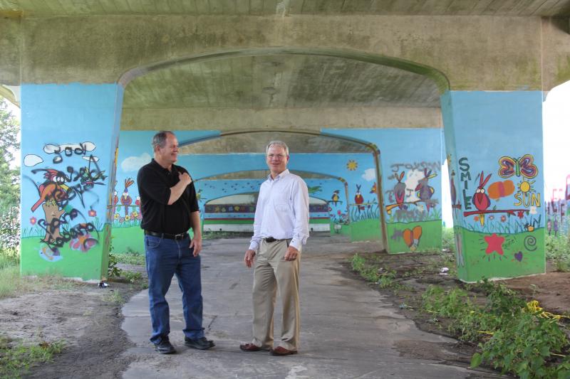 Jim Martin, left, shows Bill Allan of the Delaware Community Foundation an area under Stein Highway that ACE Peer Resource Center has beautified. MELISSA STEELE PHOTO