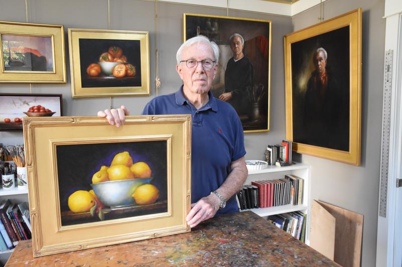 Victor Letonoff stands in his Lewes studio surrounded by his original paintings. The 82-year-old artist began his art career after a 35-year career with the U.S. Army. NICK ROTH PHOTO