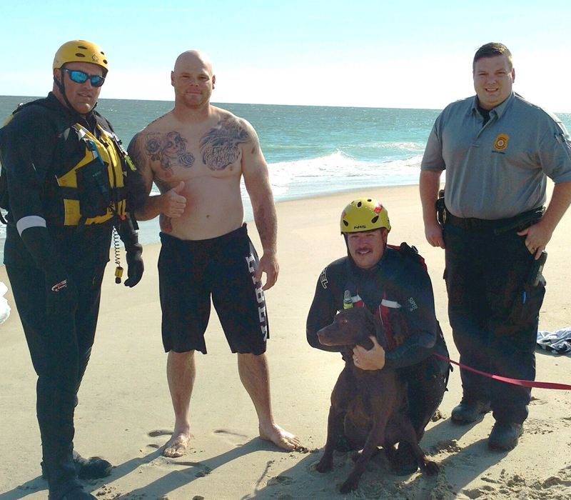 Cruz sits happily with (l-r) Bethany Beach Fire Department Deputy Chief Shane Truitt, owner Jeremy Pentoney, Bethany Beach Fire Department Chief Brian Martin and Delaware Animal Services Capt. Reed Jones. SUBMITTED PHOTO