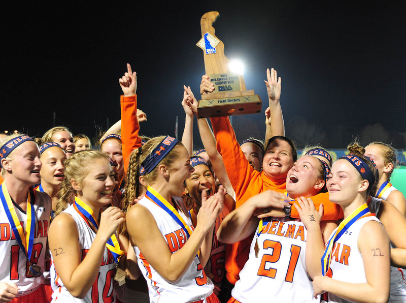 Coach Jodi Holloman and the Delmar hockey team hoist the DIAA State Championship trophy. DAN COOK PHOTO