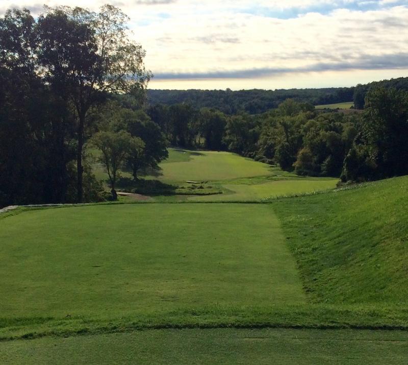 The sixth hole on the Old Course at Stonewall, site of the 2016 U.S. Mid-Amateur Championship. The tee sits atop a hill, with the fairway below split by a creek and marshy area to the right. FRITZ SCHRANCK PHOTO