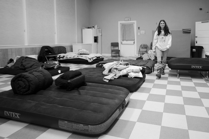 A guest passes through the multipurpose room now set up for sleeping at the Immanuel Shelter in Rehoboth. DENY HOWETH PHOTOS