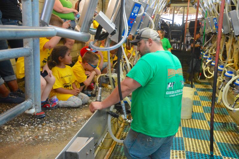 In the milking room, Noah Gesford explains how cows are milked around the clock 365 days a year at Green Acres Farm. RON MACARTHUR PHOTO