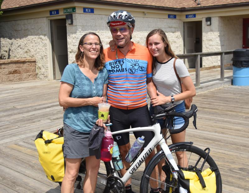 Mark Williams hugs his wife Kym and daughter Sarah after completing a 4,000-mile cross country bike ride in Rehoboth Beach. NICK ROTH PHOTOS