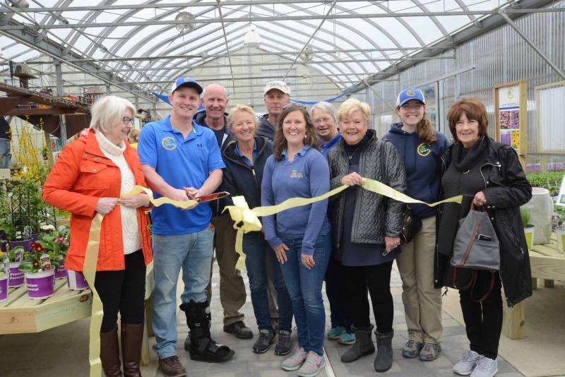 A ribbon was cut inside the expanded greenhouse. Shown are (l-r) Milton Chamber of Commerce Executive Director Terri Fox; owners Chris, Rick, Valery and Steve Cordrey; managers Katie Short and Donna Price; Milton Chamber Vice President Vicki Sammons; manager Christin Justice; and Milton Chamber’s Kathy Clark. East Coast Garden Center