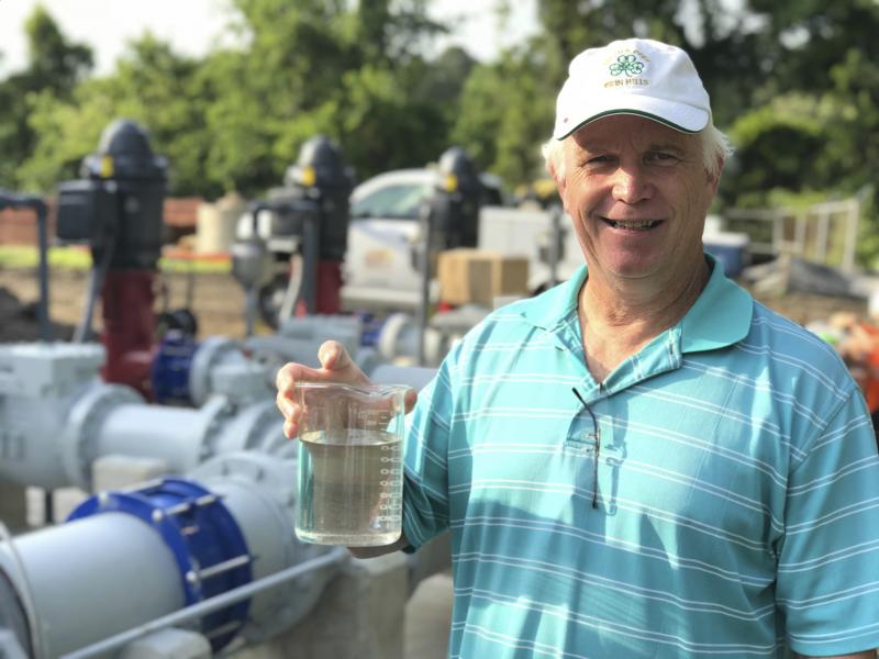 Bob Stenger has been manager of the Rehoboth Beach Wastewater Treatment Plant for the past 32 years. He holds a beaker of the filtered and treated wastewater making its way through the maze of pipes in the back ground and eventually out the end of the ocean outfall a mile off Rehoboth’s beach. DENNIS FORNEY PHOTO
