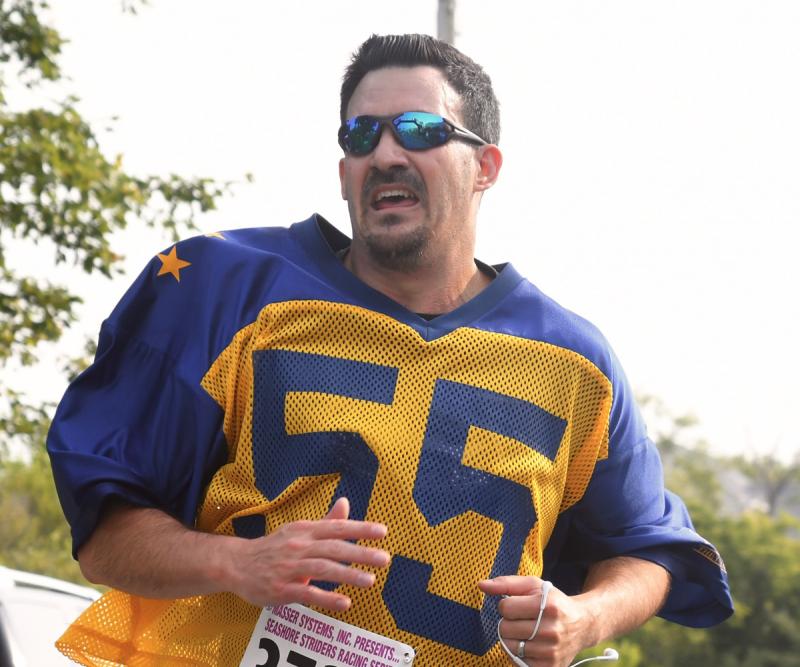 Rocket man rocking it. DJ Hughes, repping his Gold All-Star jersey from the 1994 game, runs in the Blue-Gold 5K June 9. DJ ran 24:05, jeopardizing his Lineman for Life status. DAVE FREDERICK PHOTO
