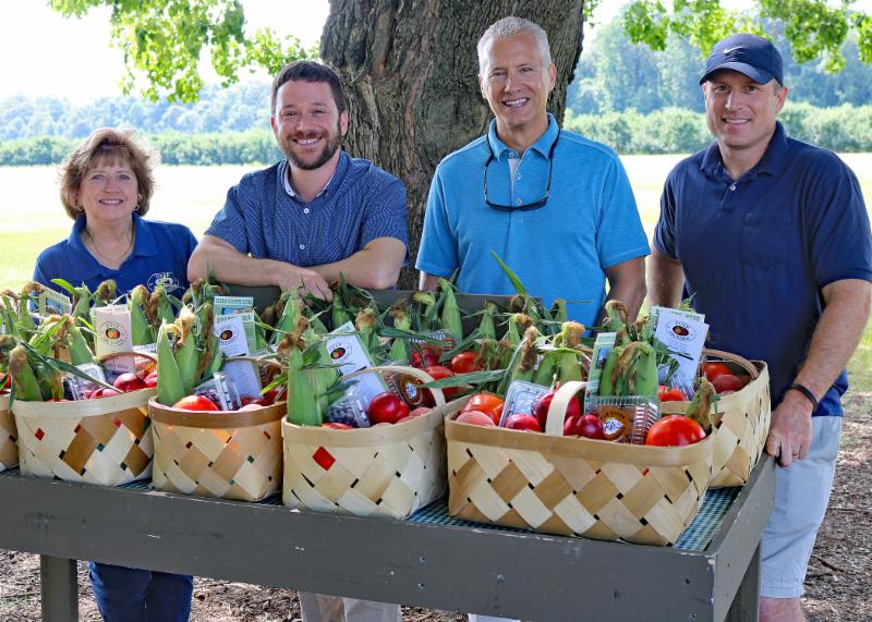 Showing off prepared baskets of local fresh produce and farm products are (l-r) Fifer Orchards co-owner Mary Fennemore, Rep. Jeff Spiegelman, Rep. Lyndon Yearick, and Fifer Orchards Vice President of Sales Curt Fifer. SUBMITTED PHOTOS