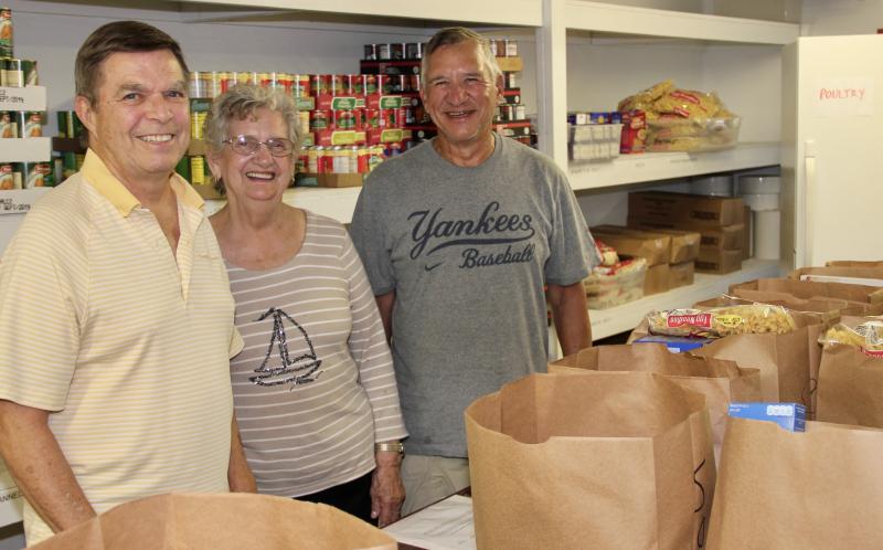 Cape Henlopen Food Basket is an all-volunteer organization. Jon DeVoll, left, is president of the board of directors, Jennie Hansen coordinates collection of food from a variety of sources, and Mike Burns, right, is one of many volunteers who visit sources like local grocery stores to pick up surplus breads and other donated items. Cape Henlopen Food Basket is open Mondays, Wednesdays and Fridays from 10 a.m. to 2 p.m. DENNIS FORNEY PHOTO