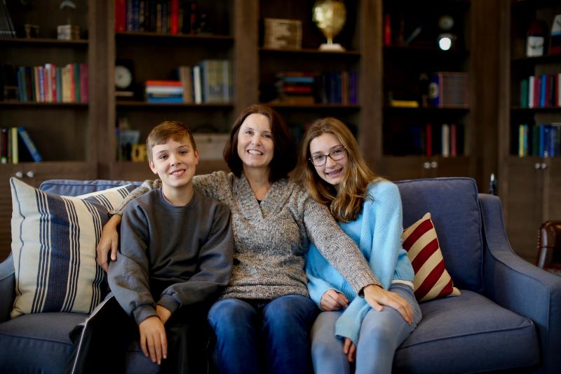 Enjoying a group hug on their couch are (l-r) Matthew, Karen, and Sarah Coty. SUBMITTED PHOTO