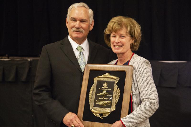 Delaware Secretary of Agriculture Michael T. Scuse, left, presents University of Delaware Provost Dr. Robin Morgan with the Secretary's Award for Distinguished Service to Delaware Agriculture. SUBMITTED PHOTO