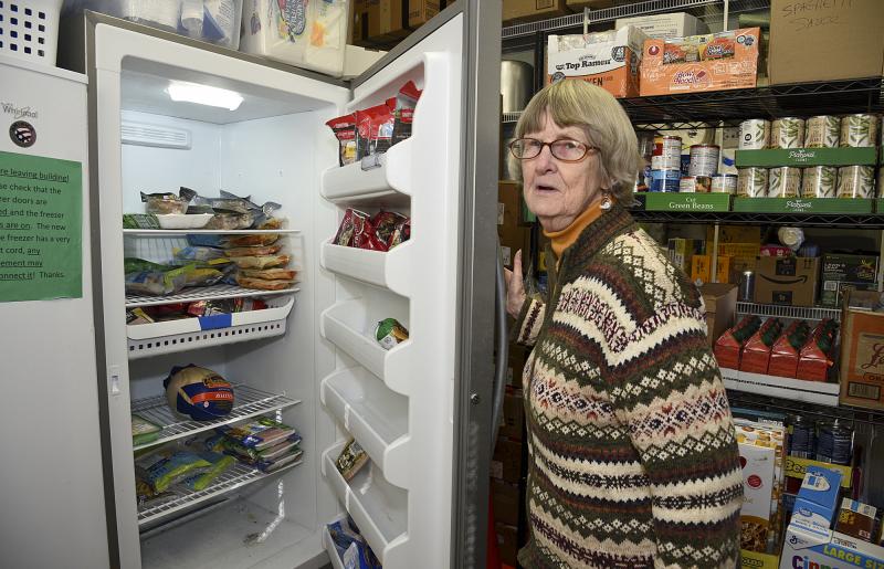 Barbara Wright shows frozen goods. The freezer was donated last year by a Milton charity.