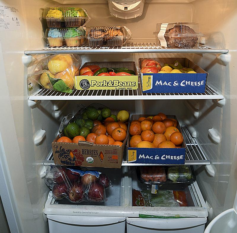Donated vegetables and fruit are held in the shared refrigerator that frequently freezes.