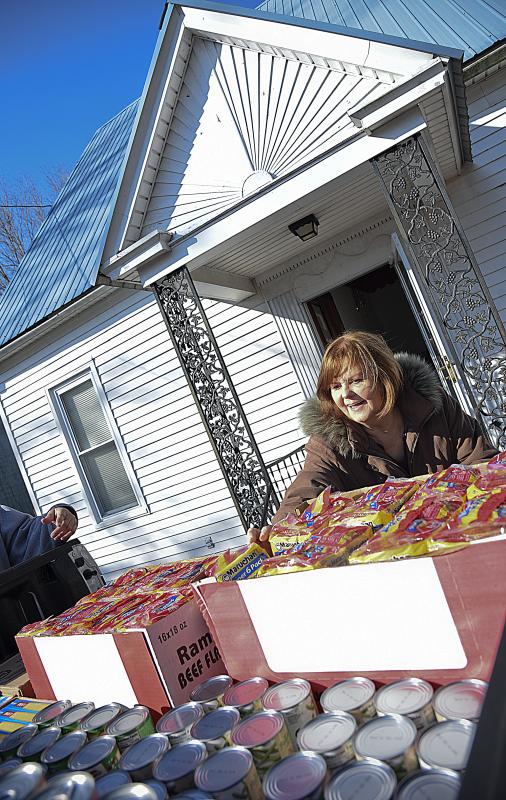 Donna Murawski is unloading goods for the week's pantry at Goshen Hall.