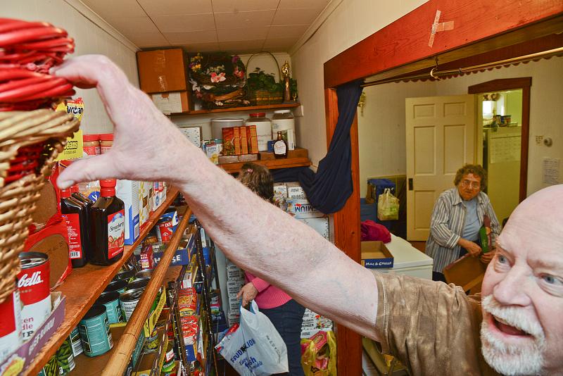 Richard Anderson reaches into the closet shelves for a basket for Elaine Brown.