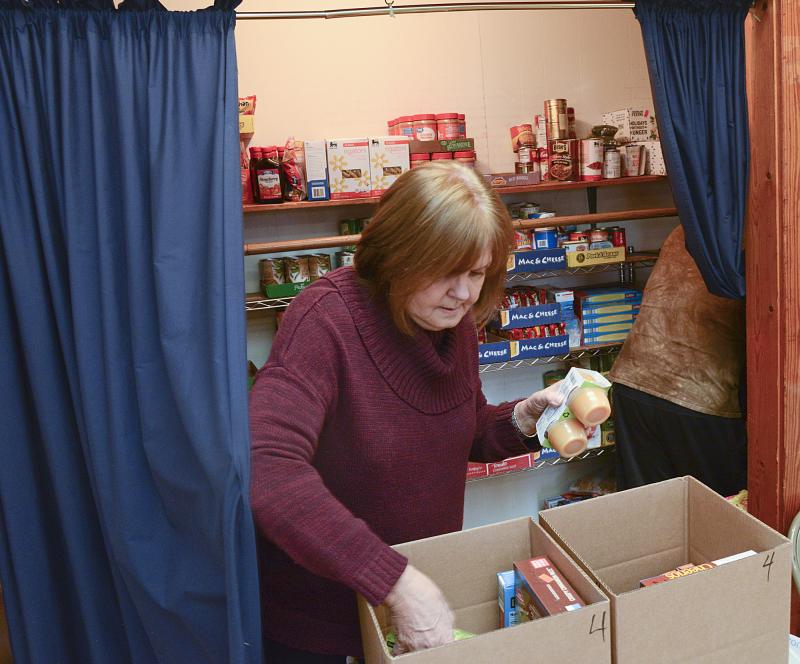 Donna Murawski prepares a box for a family of four.