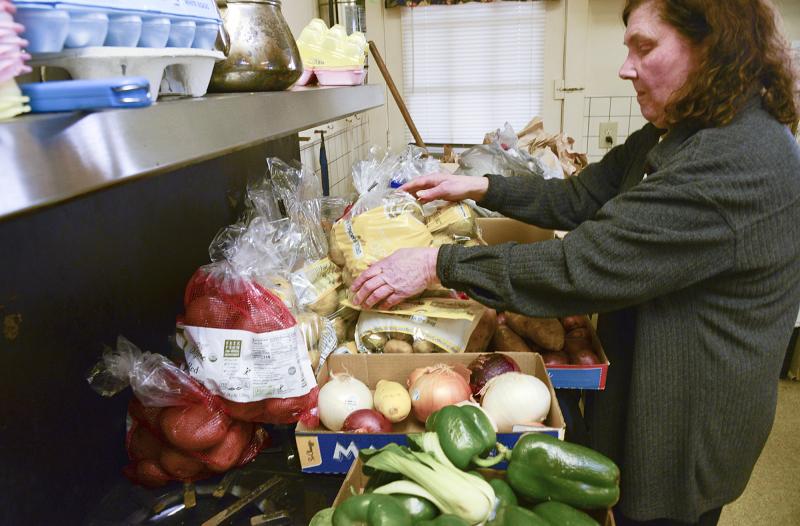 Cathy Williams sorts through donated potatoes.