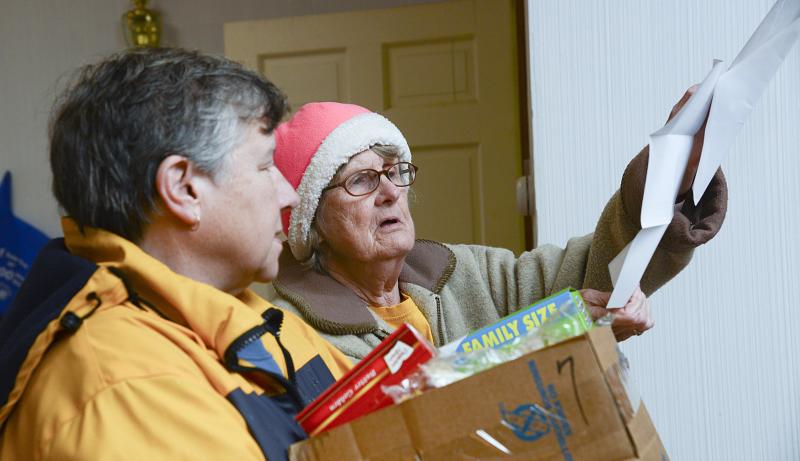 Sue Stringfield listens to Barbara Wright talk about pantry paperwork.