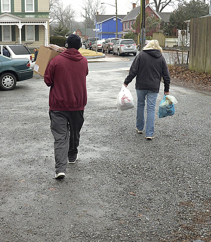 Carrying the food to cars is part of the service offered at the pantry.