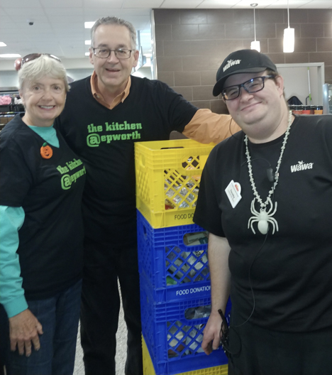 Janet Taylor-Smith and Walt Smith, left, rescue food with help from Wawa employee Timmy Morrison.