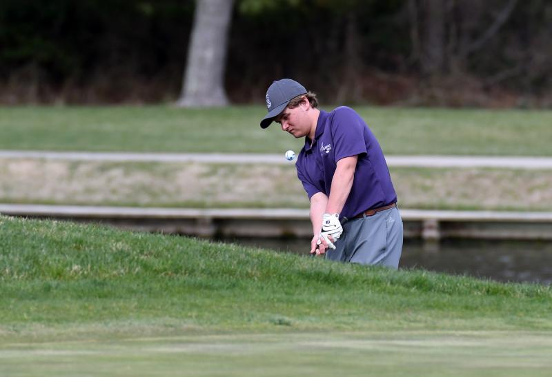 Sussex Academy senior Chris Marshall chips to the green. He shot a 48.