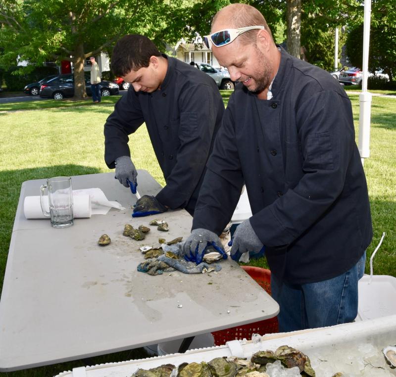 Father and son Chris and Gabriel Burns are busy shucking oysters at the start of the event.