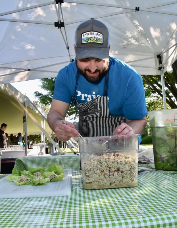 Bill Clifton, co-owner and executive chef at The Counting House on The Circle in Georgetown, prepares crab salad small plates hors d’oeuvres under a tent on Shipcarpenter Green.