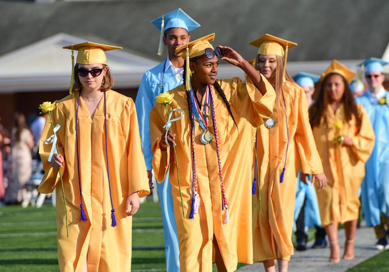Lexi Watkins looks for her family as she walks with Ashlyn Warner during the processional.