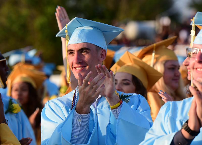 Cape grad Luke D’Ambrogi stands and applauds his parents in the stands.