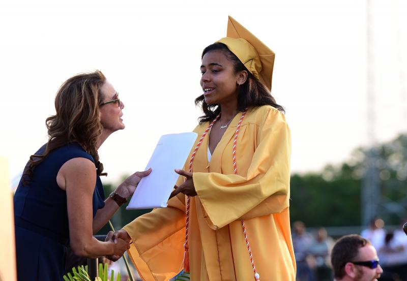 An emotional Teresa Cucinotta receives her diploma from board president Dr. Alison Myers.