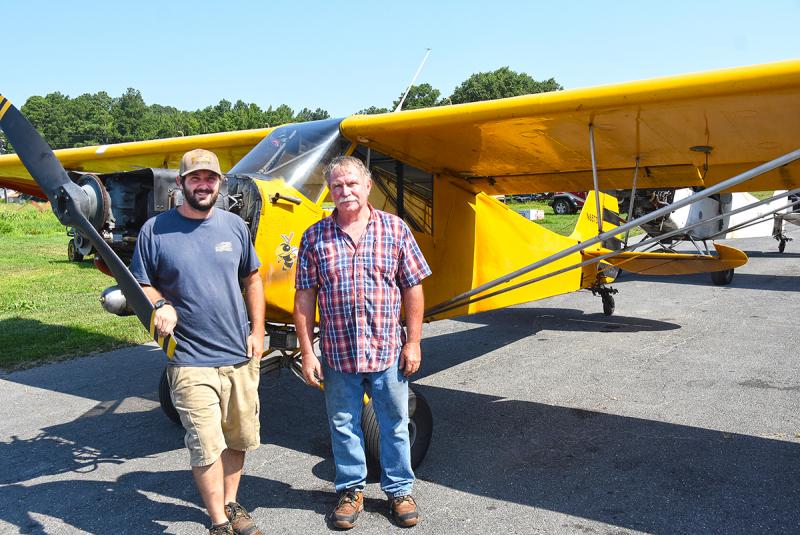 Chris and Bob Bunting stand next to one of their banner planes on the family farm near Berlin, Md. NICK ROTH PHOTOS