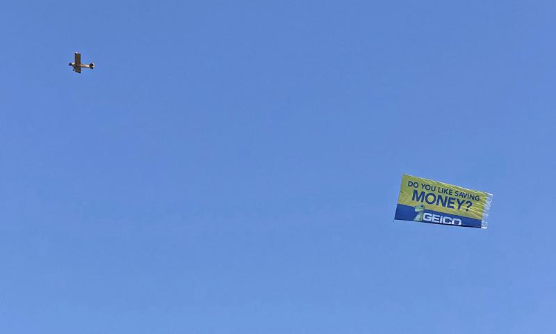 One of the Buntings’ planes tows the large Geico banner along Lewes Beach.