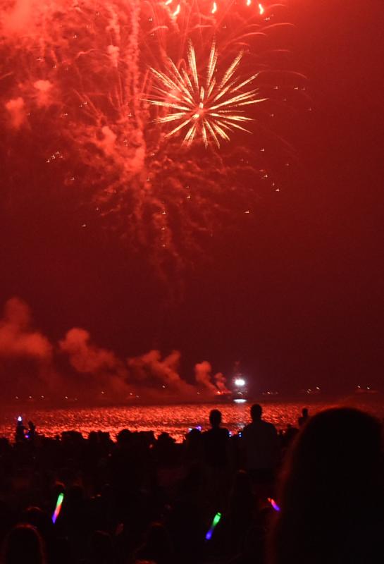 Fireworks turn the sky red over the Delaware Bay.