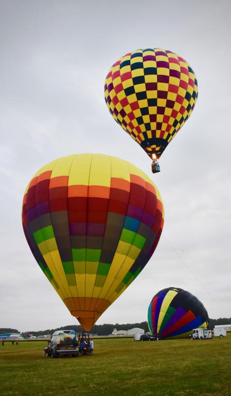 As soon as balloons are inflated, they take off in the sky over the airport.